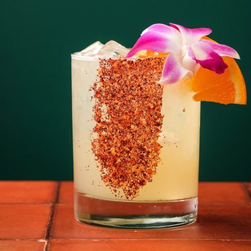Margarita with tajin rim and orange garnish